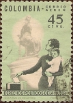 Stamps : America : Colombia :  Derechos Políticos de la Mujer (Madre y niño en las urnas con monumento).