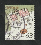 Stamps Japan -  Vehículo delante de unas viviendas