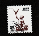 Stamps North Korea -  -niño con pájaro